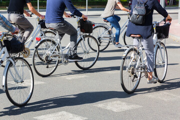 group of people riding bicycle on a city street