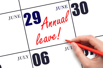 Hand writing the text ANNUAL LEAVE and drawing the sun on the calendar date June 29