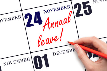 Hand writing the text ANNUAL LEAVE and drawing the sun on the calendar date November 24