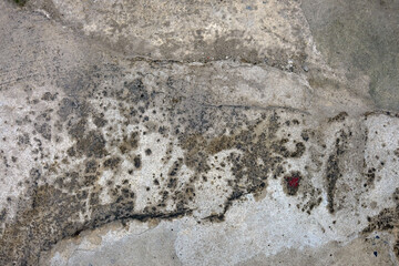texture of a concrete wall with cracks and scratches which can be used as a background