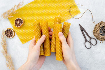 DIY - do it yourself concept. Hands making beeswax honey aroma candles - obrazy, fototapety, plakaty