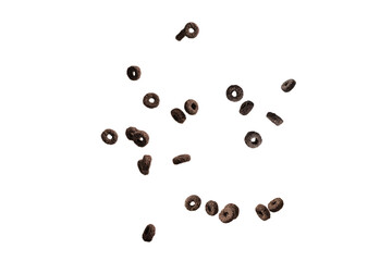 Chocolate rings cereal spill out into a bowl. Breakfast.