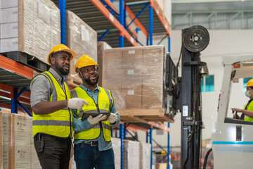 African workers holding folders for checking and inspecting on site warehouse area for shipping...