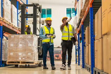 African workers holding folders for checking and inspecting on site warehouse area for shipping...