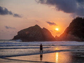 Sunset over the sea with mountains in the background