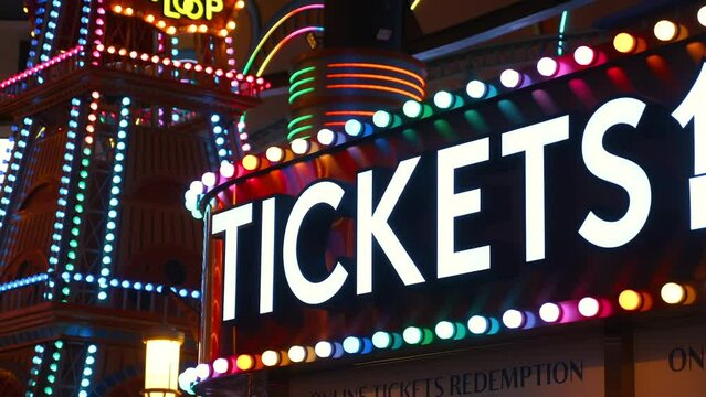 Brightly Illuminated Carnival Tickets Sign Welcomes Visitors To The Amusement Park. Colorful Vintage Design Captures The Fun And Excitement Of The Festival.