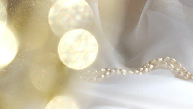 String  with natural pearls and  golden gift box and sniny  golden bokeh. Wedding, Birthday. Luxury ceremony
