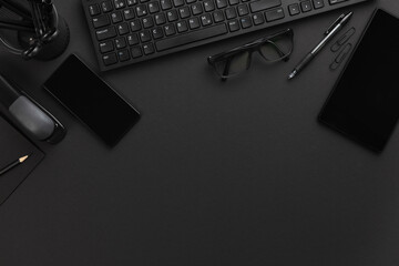 Top view of Office Desk with Supplies and Computer Keyboard On Gray Desk