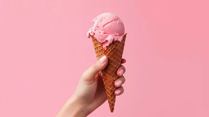 Foto auf Alu-Dibond Hand holding strawberry ice cream cone on pink background. Generative AI. © GustavsMD