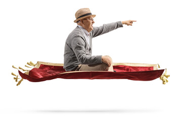 Profile shot of an elderly man flying with a red velvet carpet and pointing