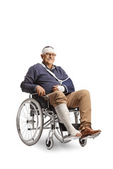 Mature man with a broken arm and bandage on head sitting in a wheelchair