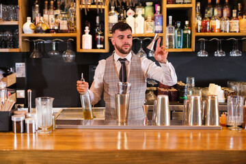 Cocktail mixologist juggling objects to prepare cocktails and putting on an entertaining show. Concept: fun, lifestyle, consumption