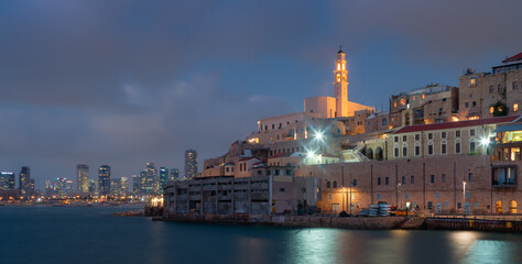 Night Jaffa and Tel Aviv skyline. Ancient city and port
