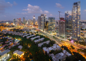 Fototapeta na wymiar Tel Aviv-Yafo, Israel - September 23, 2020: Tel Aviv aerial night view. Modern skyscrapers and green dormitory quaters