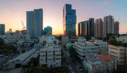 Tel Aviv sunset view: modern skyscrapers and dormitory quarters
