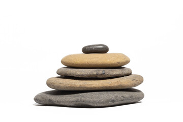 Fototapeta na wymiar A stack of five flat rocks sorted by size isolated on a white background. Zen.