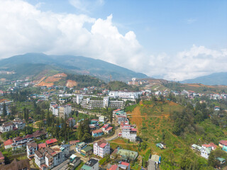 Fototapeta na wymiar Aerial view of landscape at the hill town in Sapa city, Lao Cai Province, Vietnam in Asia with the sunny light and sunset, mountain view in the clouds