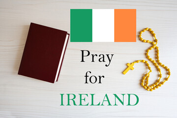 Pray for Ireland. Rosary and Holy Bible background.