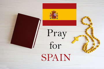 Pray for Spain. Rosary and Holy Bible background.