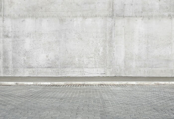 a fragment of a street city concrete wall of a building and an paving stones. Building's facade....