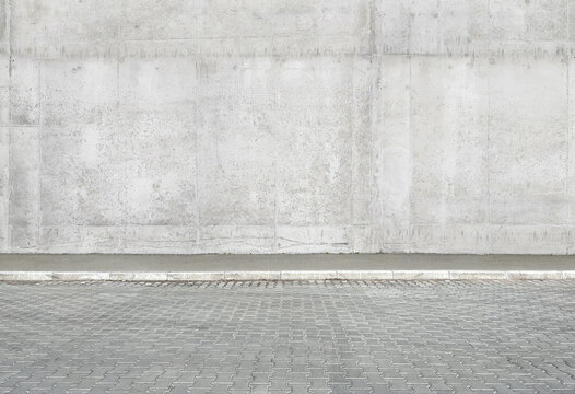 a fragment of a street city concrete wall of a building and an paving stones. Building's facade. Mocap or background for creativity
