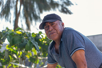 Naklejka na ściany i meble Portrait of Latino adult man in the garden