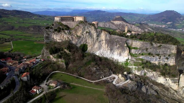 Unique beautiful places of Italy. Emilia Romagna region. Aerial drone view of impressive San Leo medieval castle located in the top of sandstone rock and village