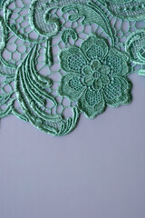 Vintage lace fabric with floral ornament, lace pattern on a light background.