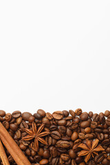 Coffee beans with spices anise and cinnamon border on white background. Copy space for text