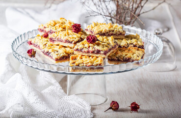Streusel pie with currant and rose petal filling on a light background.