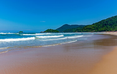 Paradise tropical beach surrounded by preserved rainforest and mountains in Bertioga on the coast of the state of Sao Paulo