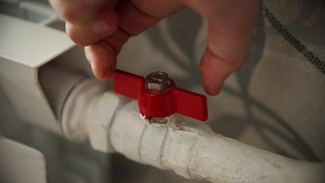 plumbing system includes brass water supply valve with stopcock handle connected to plumbing pipe