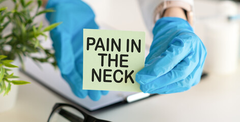 White surface lies a stethoscope and a notepad with the inscription - Pain In The Neck