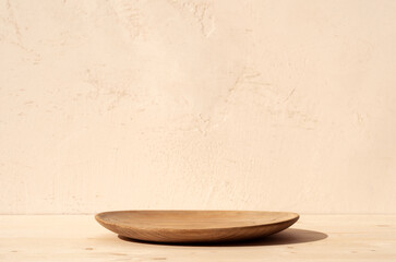 Rustic wood plate mockup and shadows on the wall. Rustic wood plate.. Mock up for food products...
