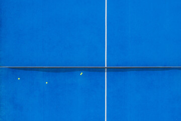 drone top view of a blue paddle tennis court