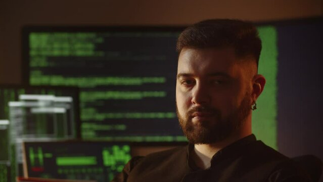 Programmer is fixing bugs. Software developer is checking system vulnerability. IT specialist is coding in the office. Hacker is breaking the code