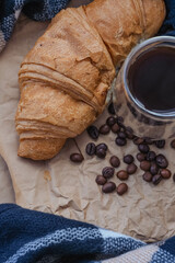 Fototapeta na wymiar Coffee beans, chocolate and croissant on paper background