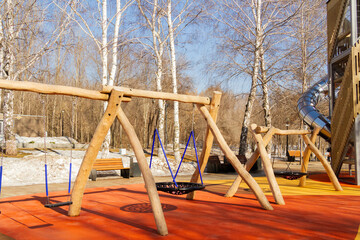 Children's playground in the park. Swings and carousels for children outdoors.