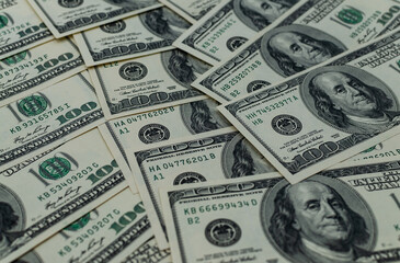 Pile of one hundred dollar bills close-up. Selective focus.