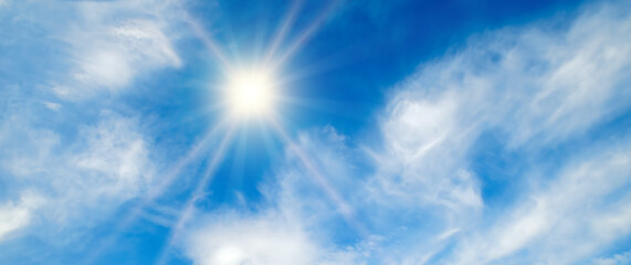 Obraz na płótnie Canvas Blue sky , sun and beautiful l clouds. Wide photo.