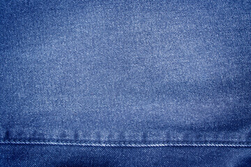 Blue denim with seams and light stains close up