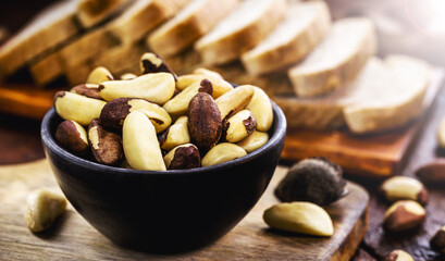 bowl with peeled Brazil nuts on a rustic table. healthy cooking ingredient