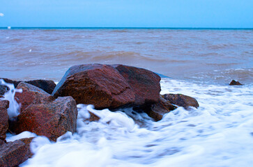 coastal stones in the surf, bubbling water