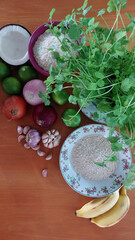 Some ingredients for food preparation distributed on a wooden bench.