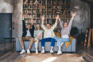 Group of cheerful mature friends having fun together at home