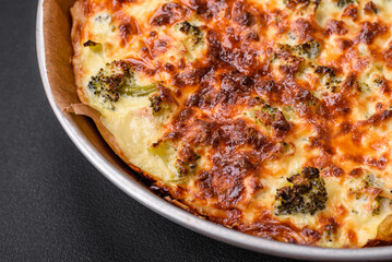 Delicious quiche with broccoli, cheese, chicken, spices and herbs
