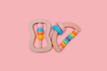 Cute set of wooden rattles. Eco-friendly toys for newborns in the colors of the rainbow. Flat lay.