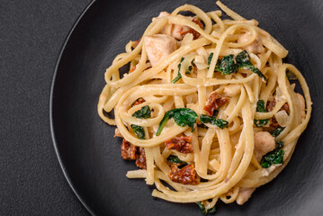 Delicious pasta with spinach, sun dried tomatoes, cheese, onions