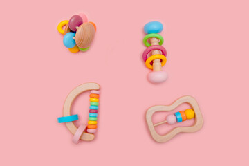 Cute rainbow set of wooden rattles . Eco-friendly toys for newborns in the colors. Flat lay, copy space.