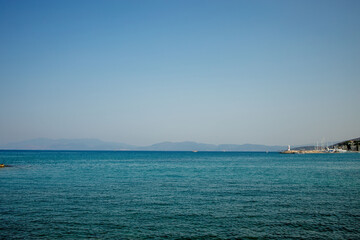 Fototapeta na wymiar A view of a populated Turkish city on the seashore. Mountain horizon of the seashore